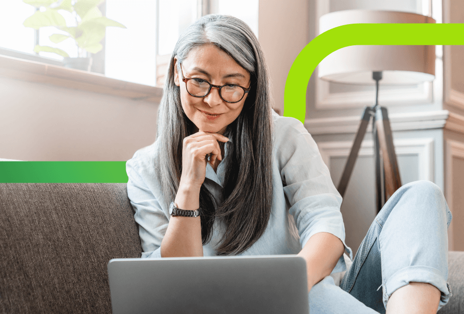 woman sitting on couch looking at a laptop
